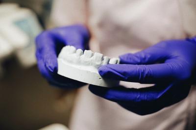 Dentist holding a mold of teeth for dental crown fittings
